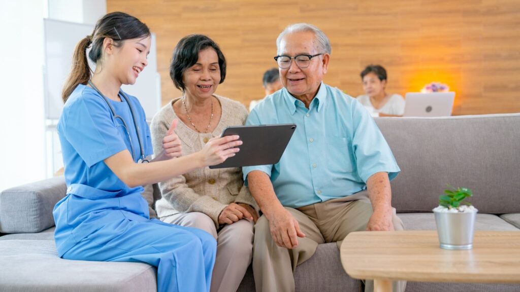 An elderly couple reviewing financial documents with a nurse, showing 70% of seniors need long-term care costing $100,000 annually, with only 3% covered by Medicare, urging early insurance planning.