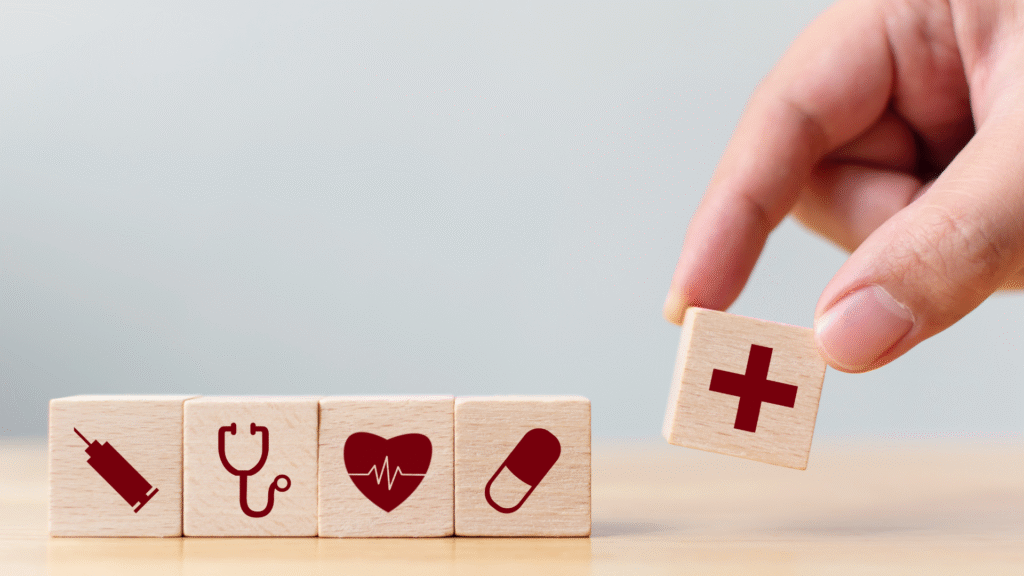 Wooden blocks with medical icons representing healthcare and wellness, symbolizing the benefits of personalized medicine for employees in improving health and workplace wellbeing.